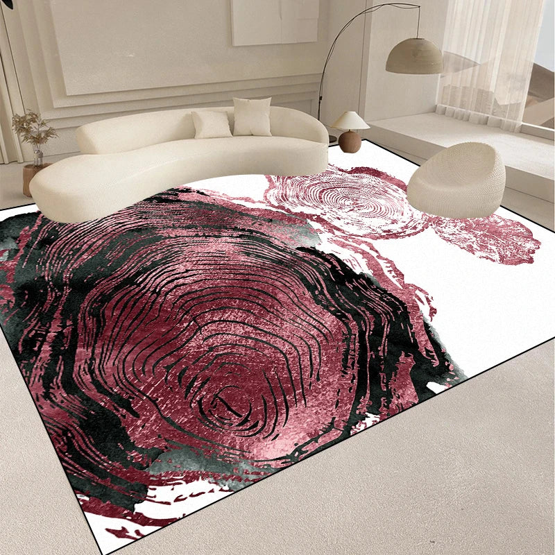 Tapis contemporain aux motifs abstraits en tons roses et rouges, créant un effet de profondeur et de mouvement, donnant une touche artistique et élégante à l'intérieur.