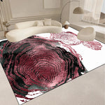 Tapis contemporain aux motifs abstraits en tons roses et rouges, créant un effet de profondeur et de mouvement, donnant une touche artistique et élégante à l'intérieur.