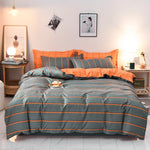 Housse de couette rayée grise et orange réversible sur lit Queen Size