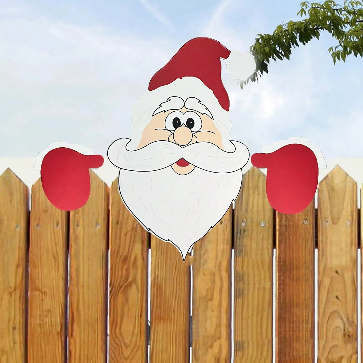 Panneau Père Noël rouge accroché à une clôture de jardin