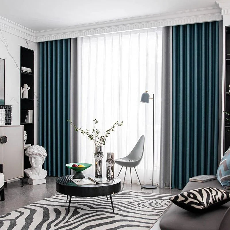 Salon moderne et élégant avec rideaux bleu foncé, voilages blancs, et décoration contemporaine. Espace lumineux complété par un tapis imprimé zèbre, table basse noire, et objets décoratifs stylés. Ambiance chic et sophistiquée idéale pour un intérieur design.