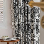 Rideau à motifs noirs sur fond blanc décorant un salon contemporain. Idéal pour ajouter une touche élégante et intemporelle à votre intérieur, ce rideau offre une belle intégration avec une décoration moderne. Parfait pour filtrer la lumière tout en créant une ambiance chaleureuse et accueillante.