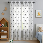 Voilage blanc avec motifs de ballons de football dans une chambre d'enfant lumineuse, décorée dans un style doux et moderne avec un lit, une étagère et des jouets adaptés aux enfants.
