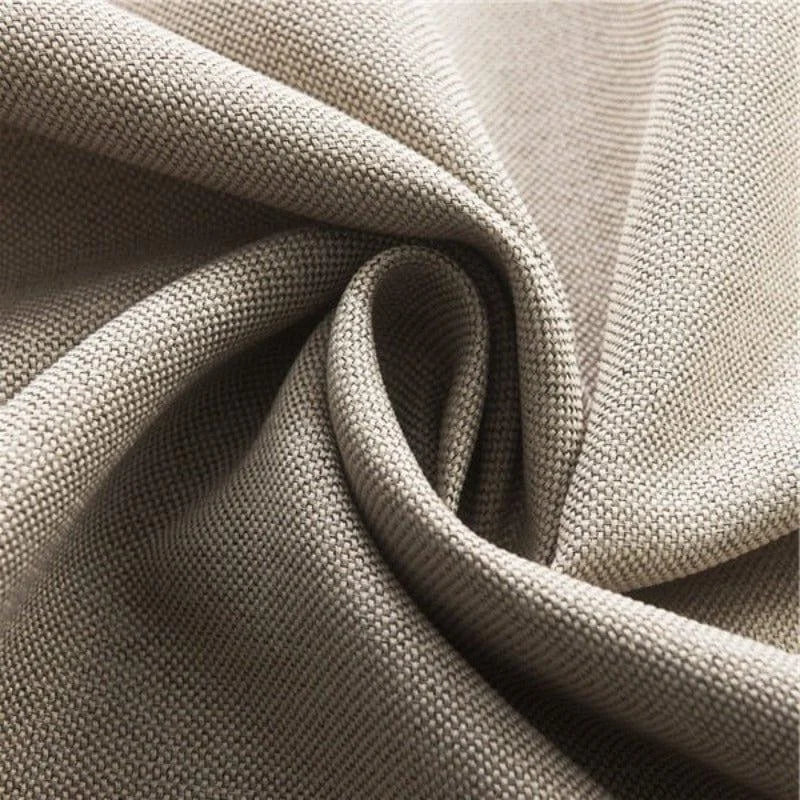 Tissu beige texturé, idéal pour la confection de rideaux et d'ameublement, offrant une allure élégante et un style intemporel pour la décoration intérieure.