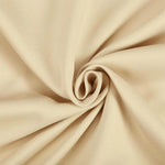 Tissu beige enroulé en spirale, idéal pour la confection de vêtements et décoration intérieure, offrant élégance et douceur visuelle. Parfait pour ajouter une touche de sophistication à vos projets artisanaux.