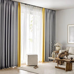Rideaux élégants dans un salon moderne, combinant des teintes grises et jaunes pour un effet décoratif sophistiqué. Ils offrent une ambiance lumineuse et accueillante, idéale pour les intérieurs contemporains. La pièce est aménagée avec des meubles en bois et des éléments décoratifs naturels, créant un espace chaleureux et stylé.