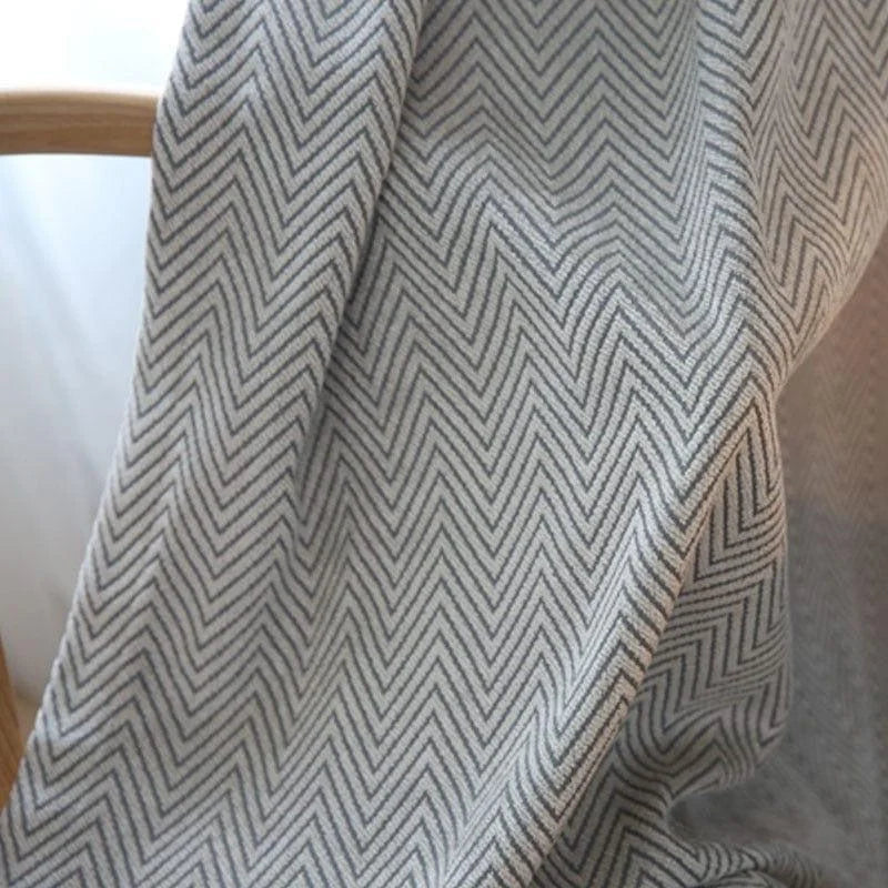 Plaid élégant à motif chevrons gris, parfait pour une décoration intérieure moderne et cosy. Accessoire idéal pour ajouter une touche de style à votre salon ou chambre.