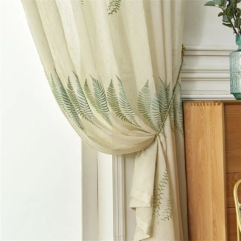 Rideau décoratif à motif de fougères, habillant élégamment une fenêtre avec une touche naturelle et raffinée. Idéal pour ajouter une ambiance apaisante à votre intérieur, ce rideau avec motif végétal offre à la fois esthétique et fonctionnalité. Parfait pour salons ou chambres, il complète harmonieusement votre décoration.