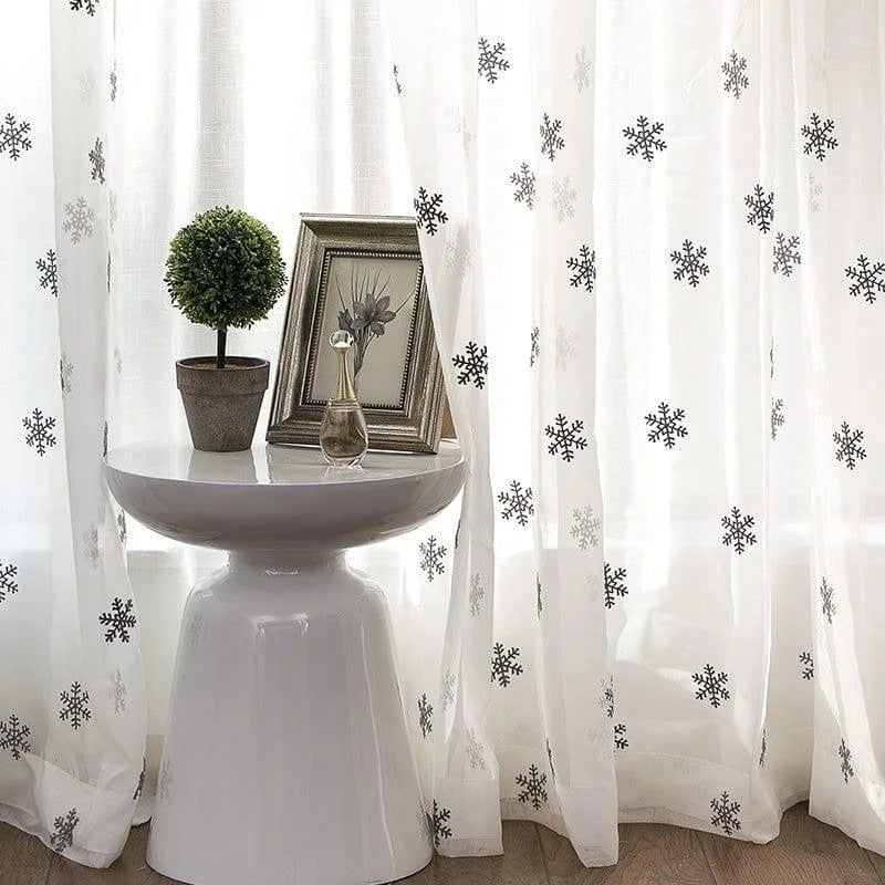 Voilage élégant avec motif flocons de neige, idéal pour ajouter une touche de charme hivernal à votre décoration intérieure. Disponible avec une table moderne et des accessoires décoratifs pour un style raffiné et sophistiqué. Parfait pour illuminer votre salon ou chambre à coucher avec une ambiance chaleureuse et accueillante.