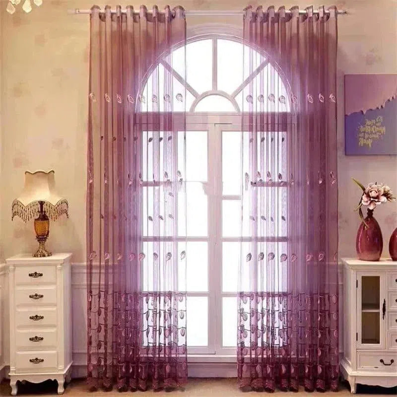 Rideaux élégants de couleur rose pâle, parfaits pour sublimer la décoration d'une fenêtre cintrée dans un salon moderne. Ils créent une ambiance chaleureuse en laissant passer la lumière naturelle. Accessoires décoratifs, tels qu'une lampe de table classique et des vases, complètent harmonieusement cet espace intérieur raffiné.